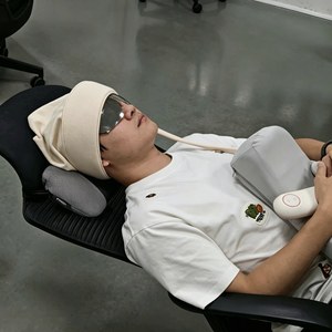 Person relaxing with a massager during an office break