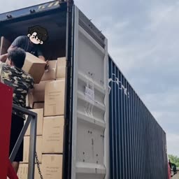 Workers loading cartons into a shipping container